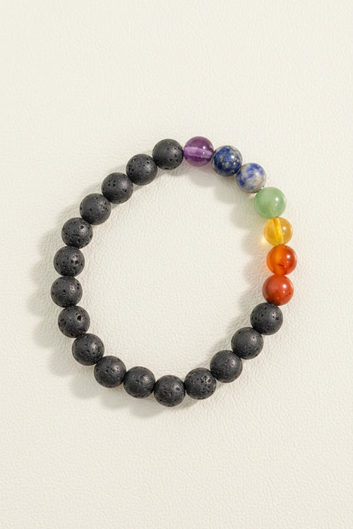 Multicolored beaded bracelet on a textured gray background