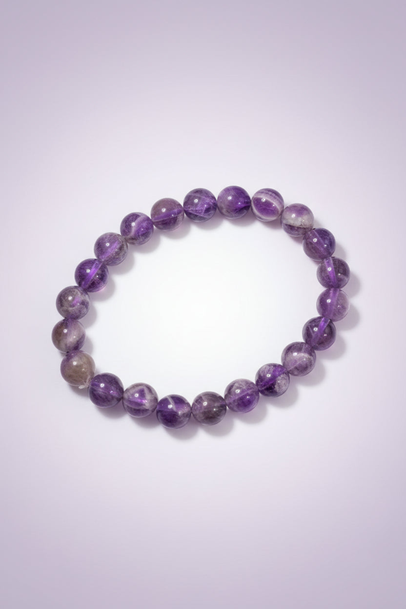 Purple beaded bracelet on a textured surface