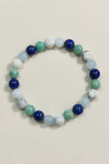 Multicolored beaded bracelet on a dark wooden surface