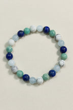 Multicolored beaded bracelet on a dark wooden surface